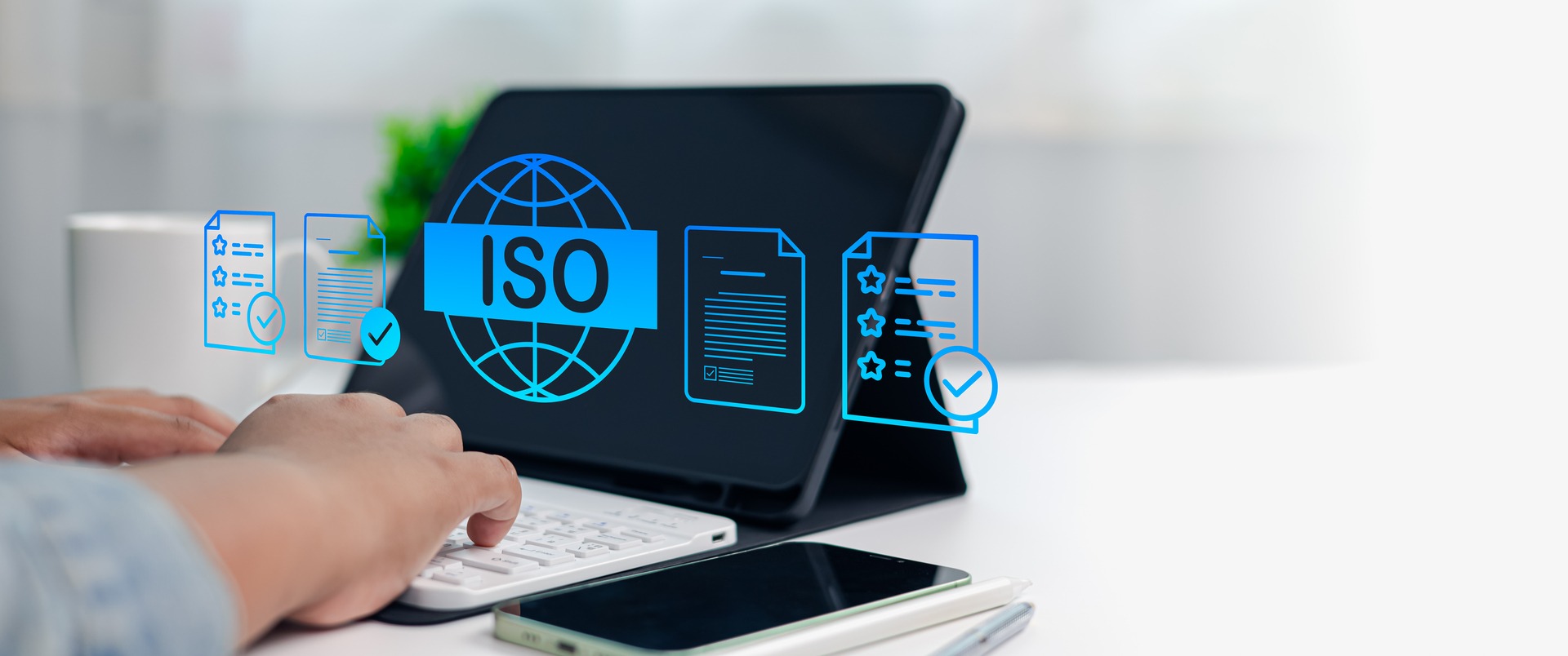 ISO 27001 certification compliance documents and audit checklist on tablet
